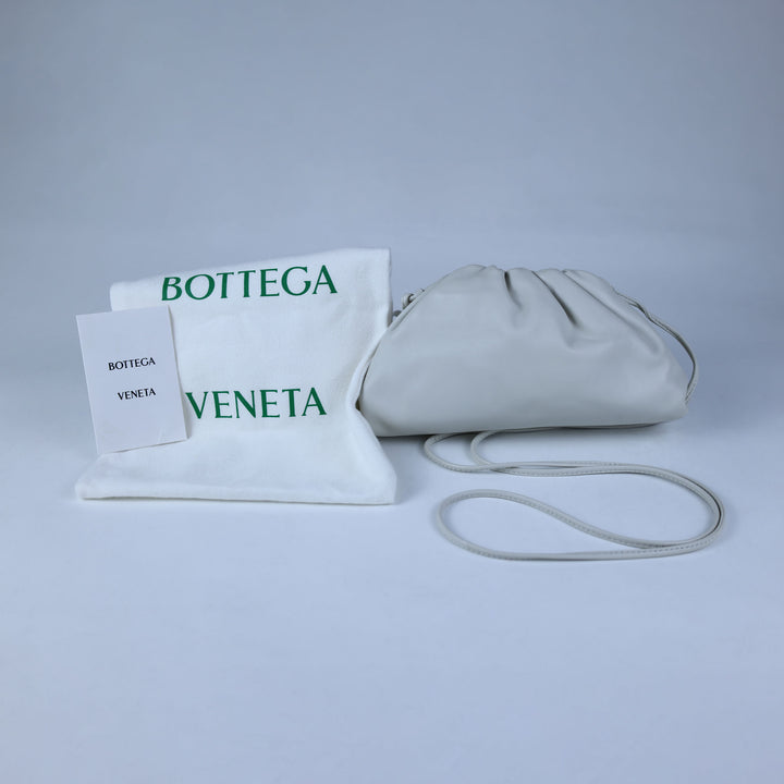 Bottega Veneta handbag with matching pouch on a light gray background