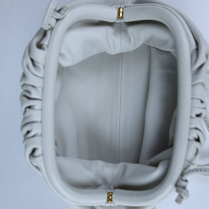 Close-up of a gray bag with decorative patterns on a light gray background