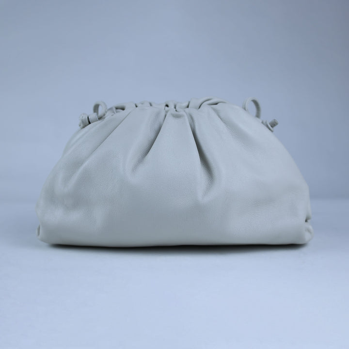 Light gray clutch bag on a light gray background