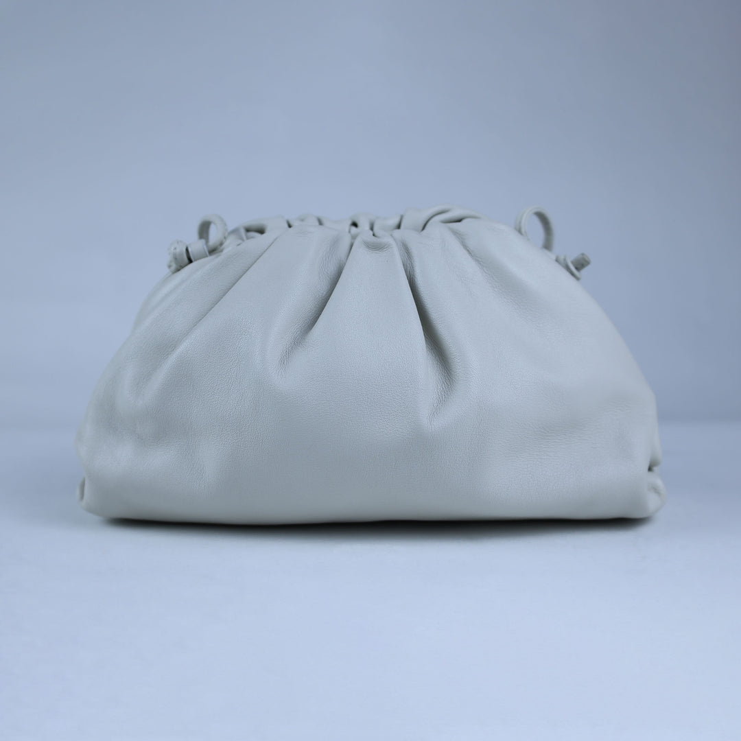 Light gray clutch bag on a light gray background